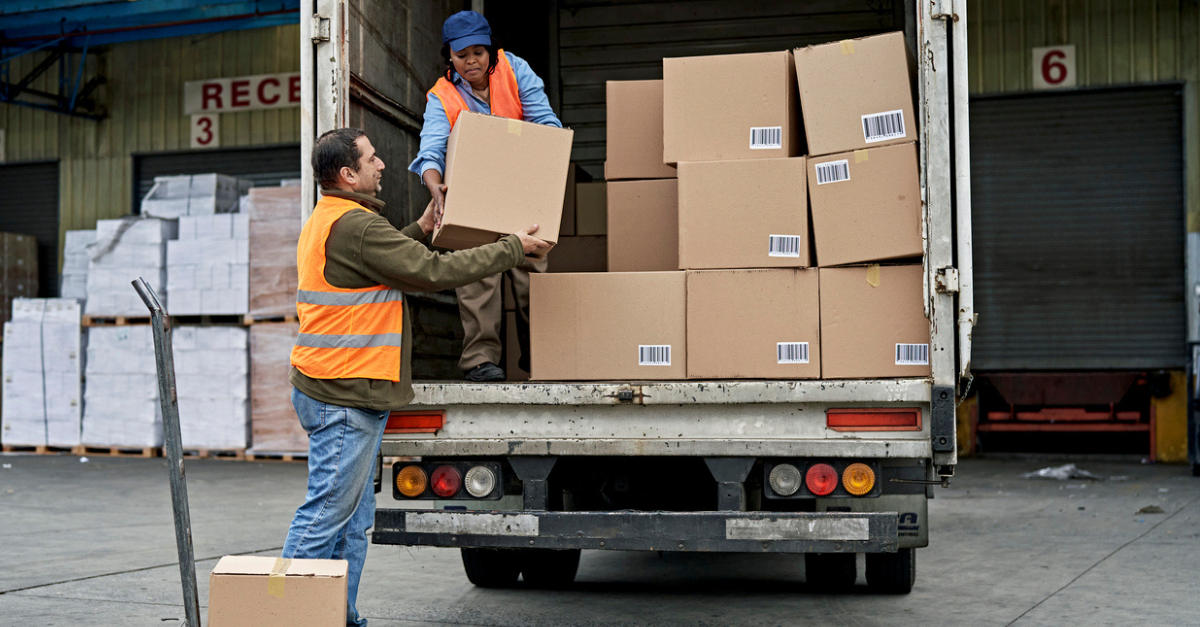 Female Truck Driver Loading Boxes in Cargo Space